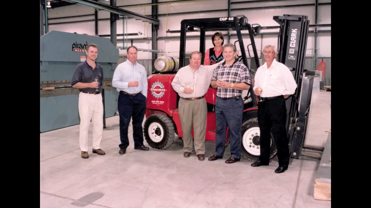 a group of people posing in front of fork-wheel