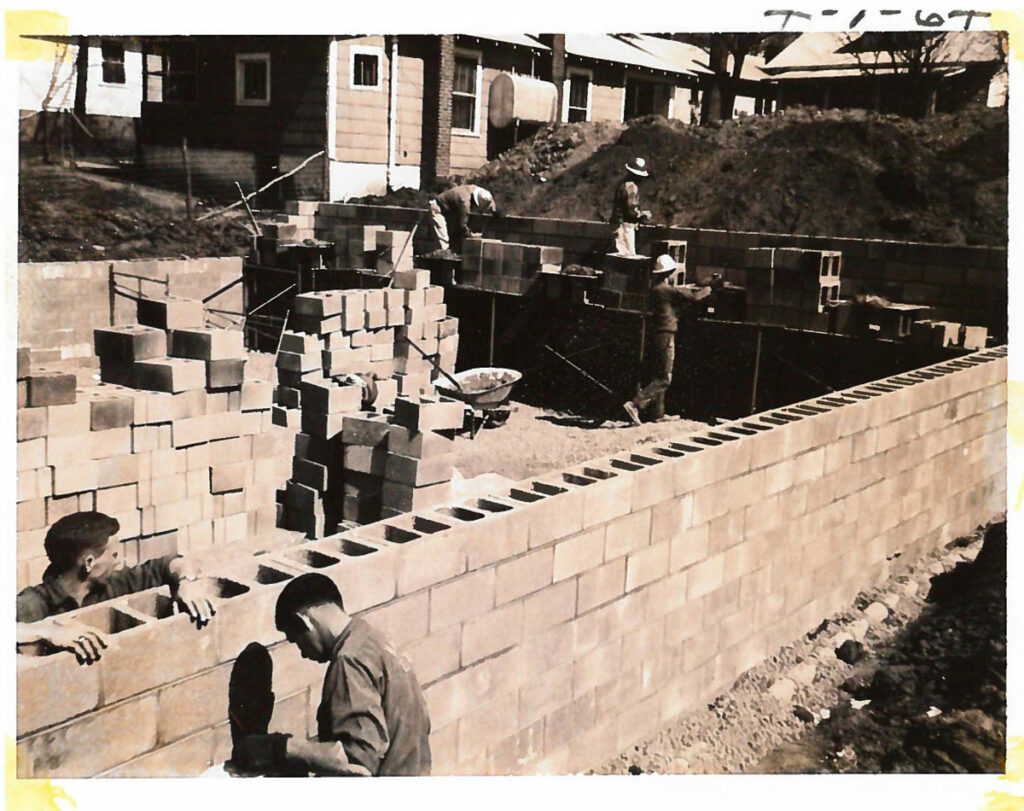 people are building the house with concrete blocks