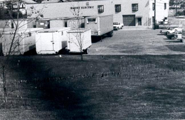 black and white photo of Massey Electric building and parking lot