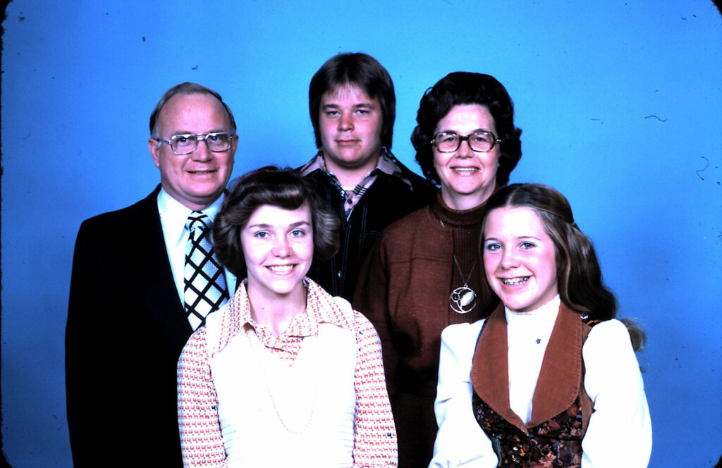 a group of people is posing in front of the blue screen